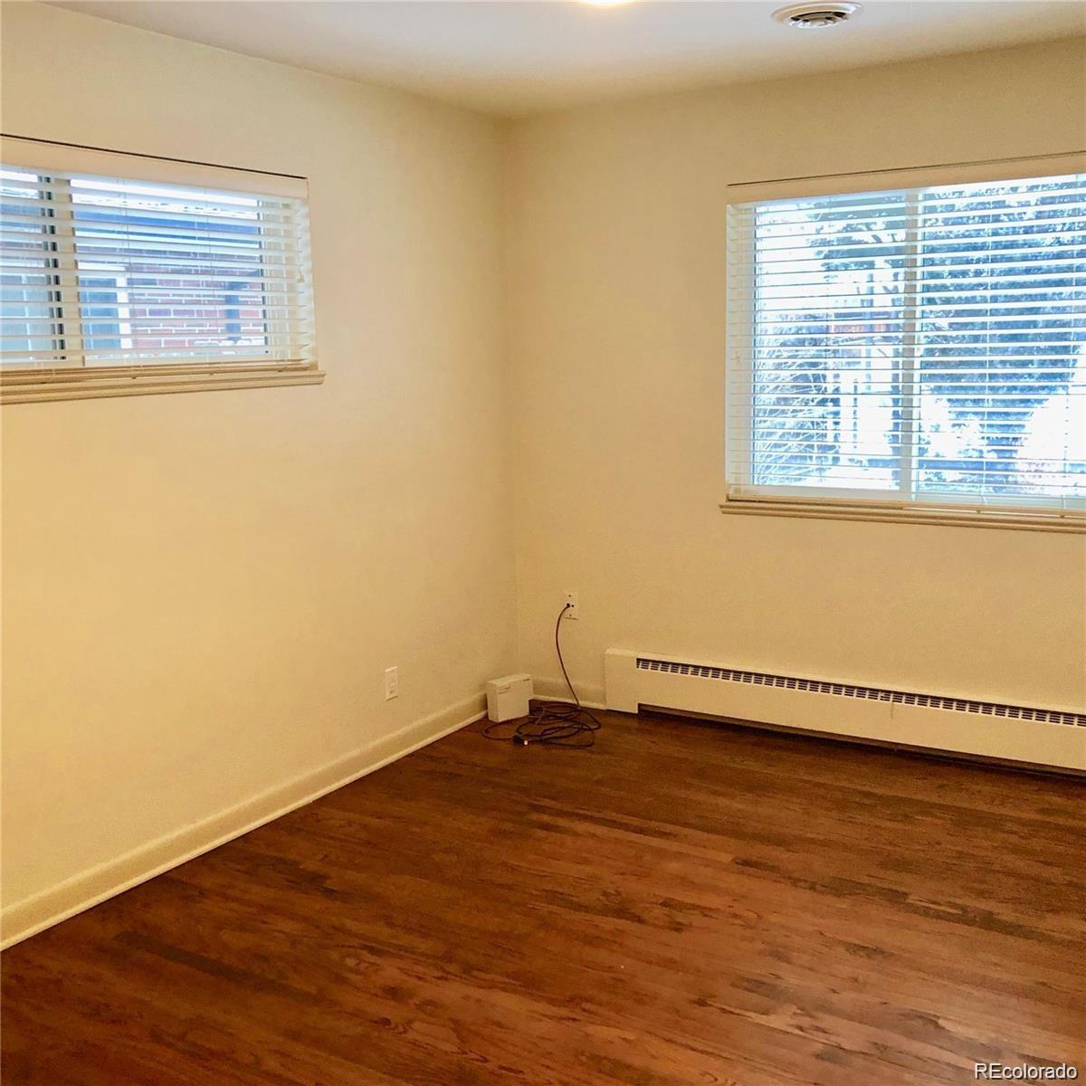 3022 South Gilpin Street Denver, CO 80210 - Photo 18 of 28 a view of an empty room with wooden floor and a window