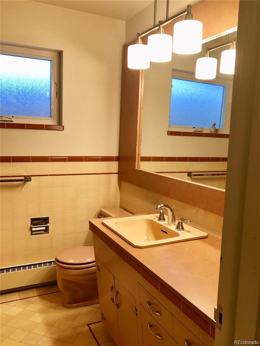 3022 South Gilpin Street Denver, CO 80210 - Photo 20 of 28 a bathroom with a sink and a mirror
