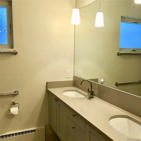 a bathroom with a sink toilet and mirror