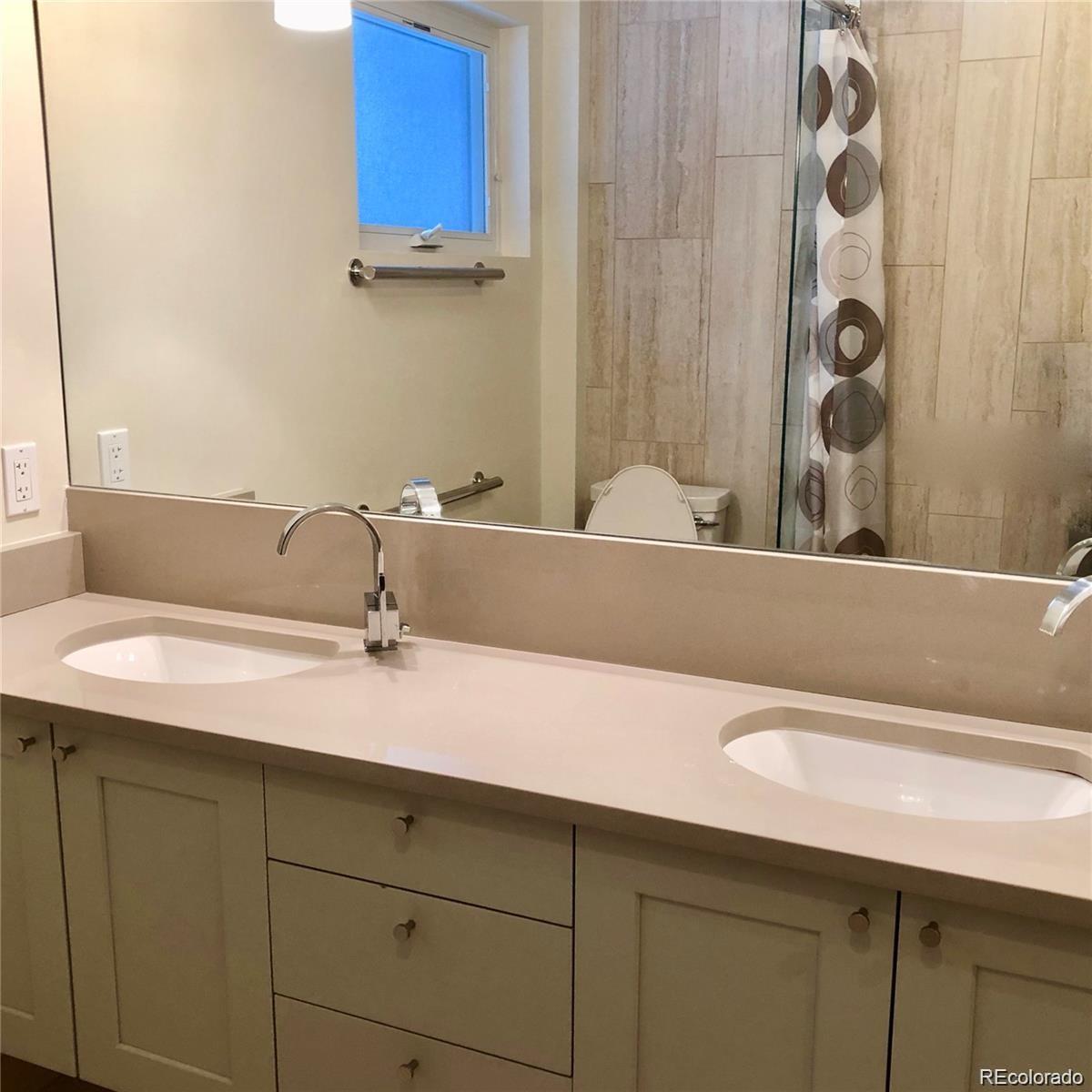 3022 South Gilpin Street Denver, CO 80210 - Photo 27 of 28 a bathroom with a sink and a mirror