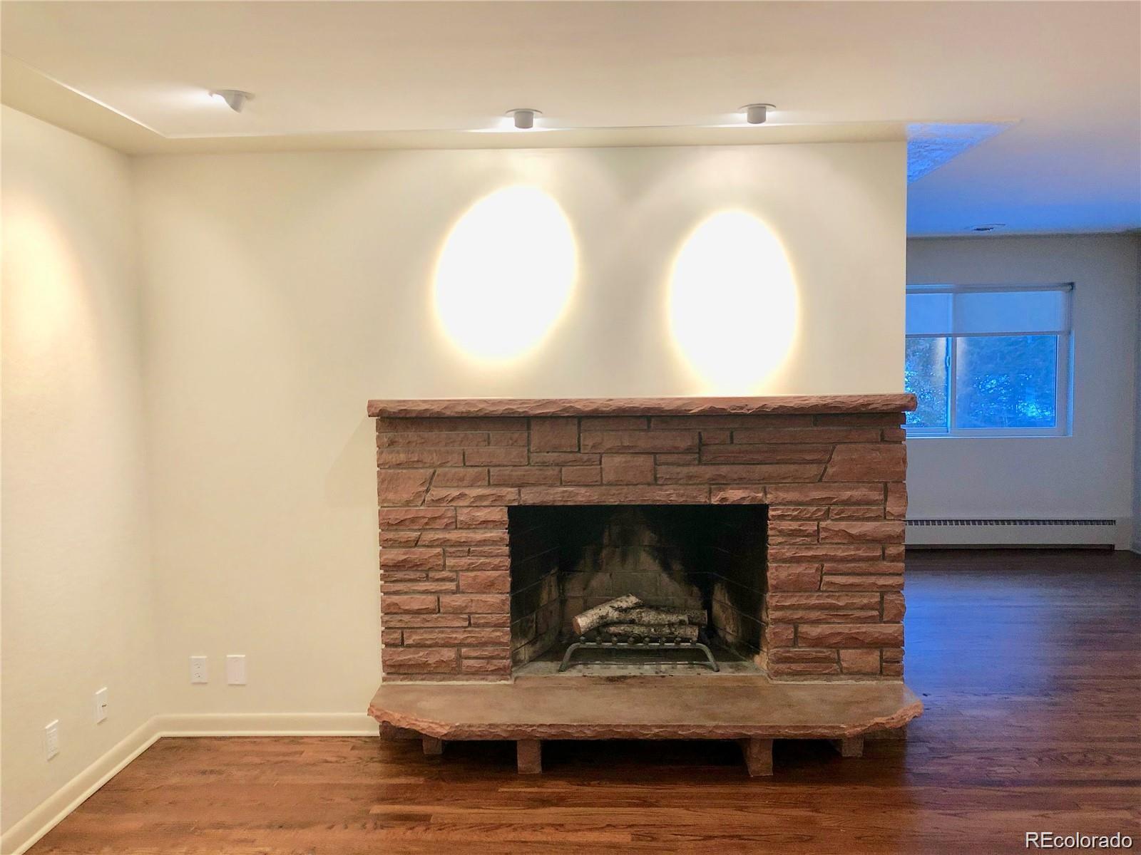 3022 South Gilpin Street Denver, CO 80210 - Photo 3 of 28 a living room with a fireplace