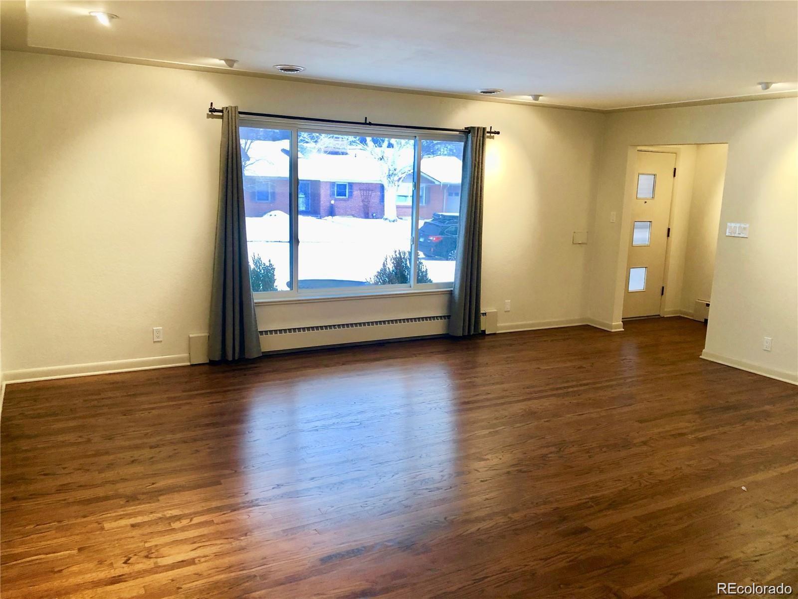 3022 South Gilpin Street Denver, CO 80210 - Photo 5 of 28 a view of room with window and wooden floor