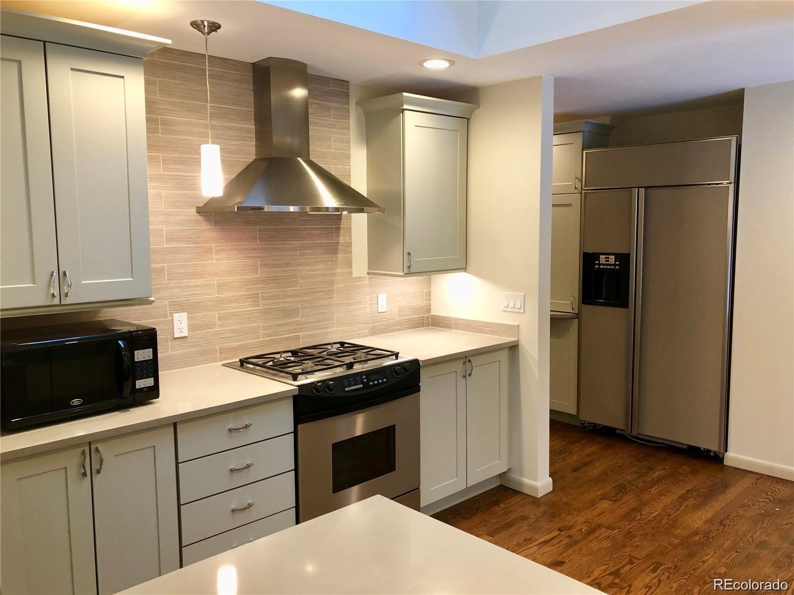 3022 South Gilpin Street Denver, CO 80210 - Photo 7 of 28 a kitchen with stainless steel appliances granite countertop a stove and a refrigerator