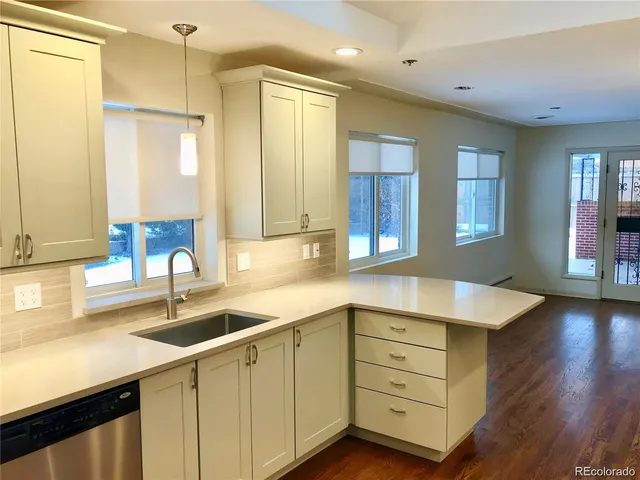 a kitchen with a sink cabinets and wooden floor