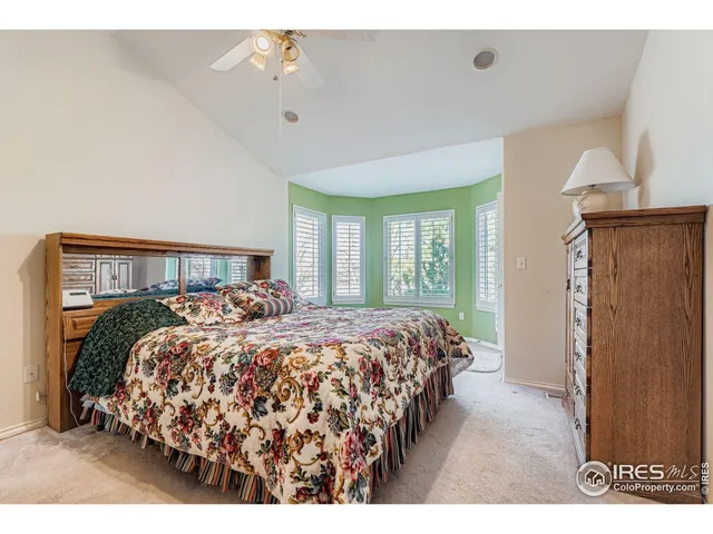 a bed room with a bed mirror and a window