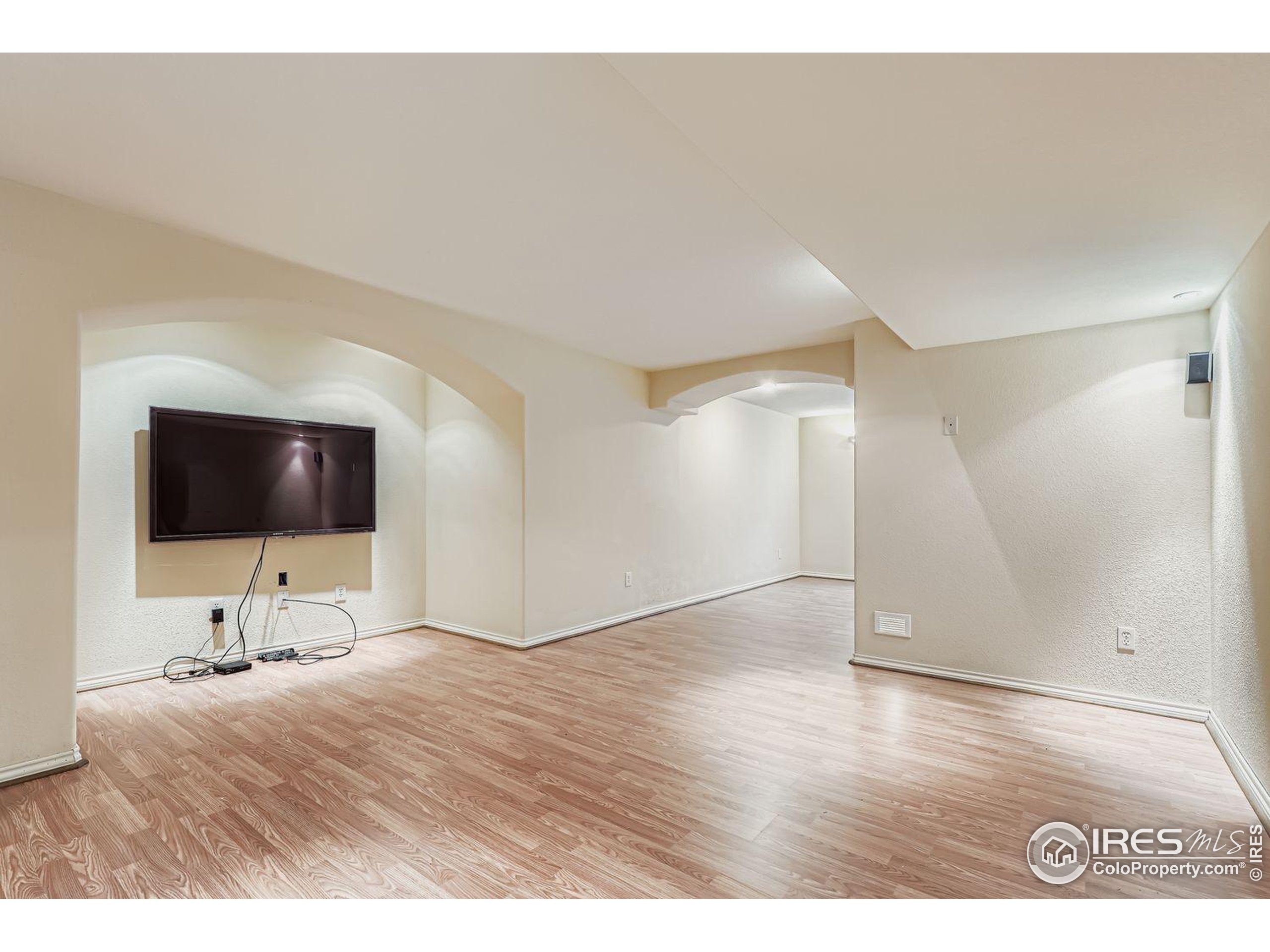 569 Flying Jib Court Lafayette, CO 80026 - Photo 26 of 31 a view of a livingroom with wooden floor and a flat screen tv