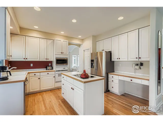 a kitchen with wooden cabinets and stainless steel appliances