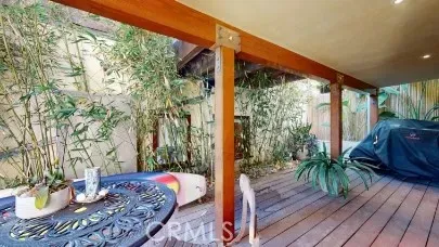 a living room with stainless steel appliances furniture a fireplace and a flat screen tv