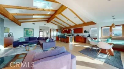 a living room with patio furniture and a large window
