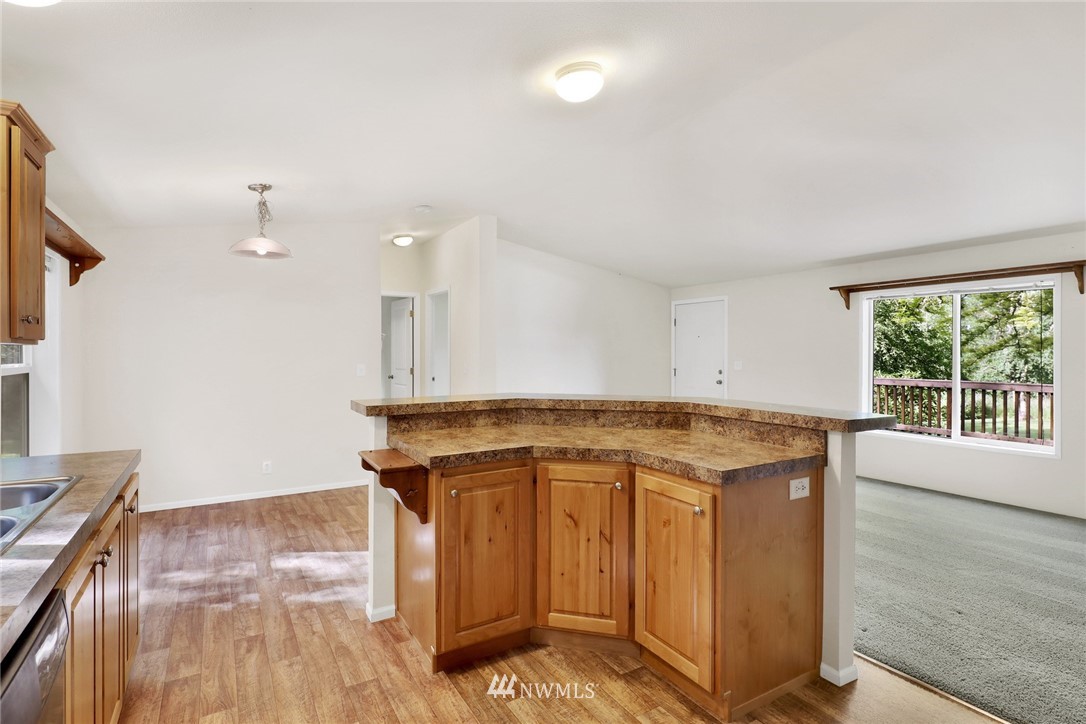 6752 Goodwin Road Everson, WA 98247 - Photo 12 of 28 a kitchen with stainless steel appliances granite countertop a stove a sink and a microwave