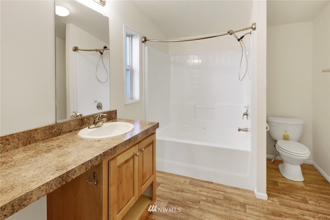 6752 Goodwin Road Everson, WA 98247 - Photo 18 of 28 a bathroom with a granite countertop sink toilet and shower