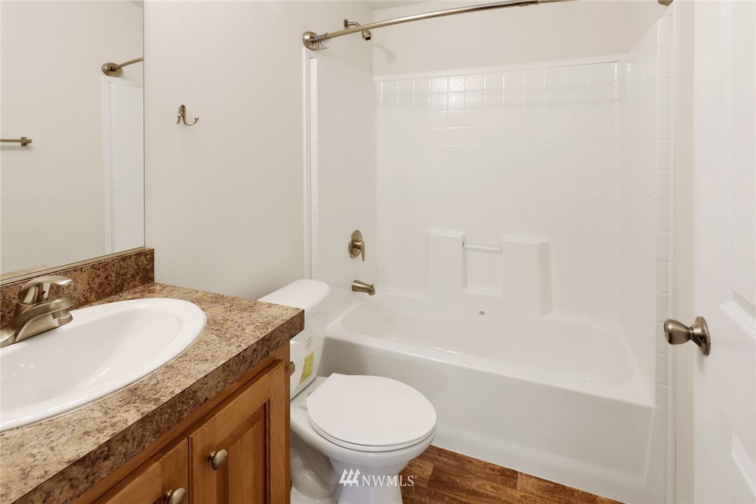 6752 Goodwin Road Everson, WA 98247 - Photo 19 of 28 a bathroom with a granite countertop sink toilet and shower