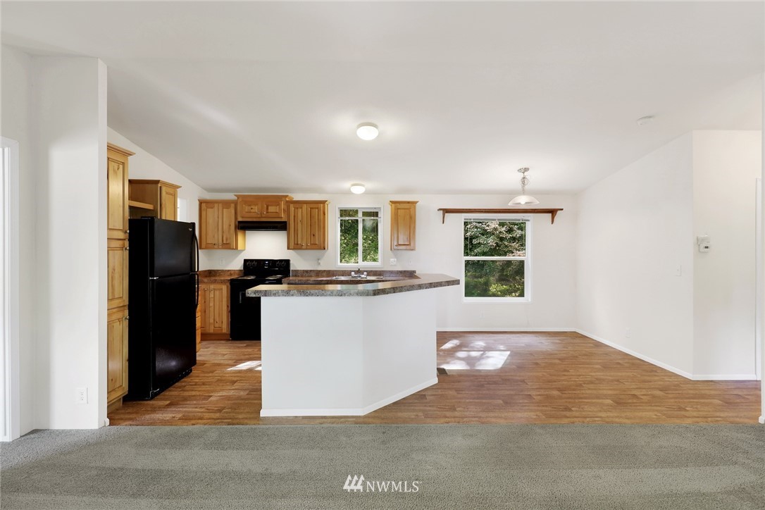6752 Goodwin Road Everson, WA 98247 - Photo 8 of 28 a kitchen with a refrigerator and a stove top oven