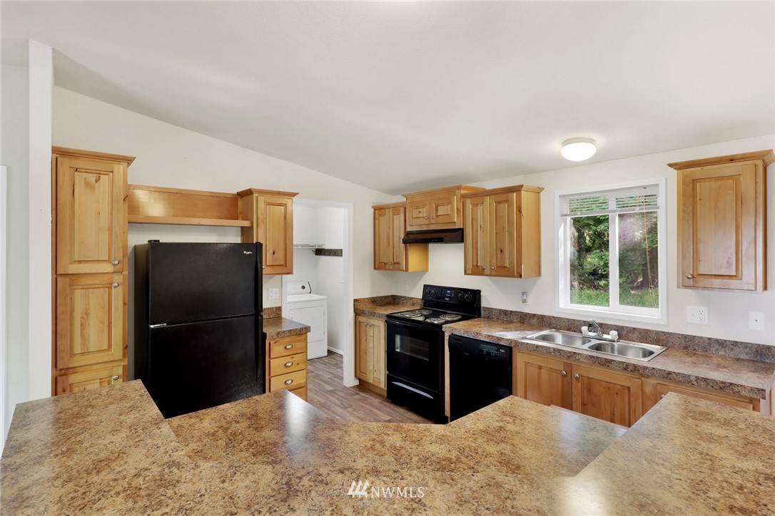 6752 Goodwin Road Everson, WA 98247 - Photo 9 of 28 a kitchen with stainless steel appliances granite countertop a refrigerator and a sink