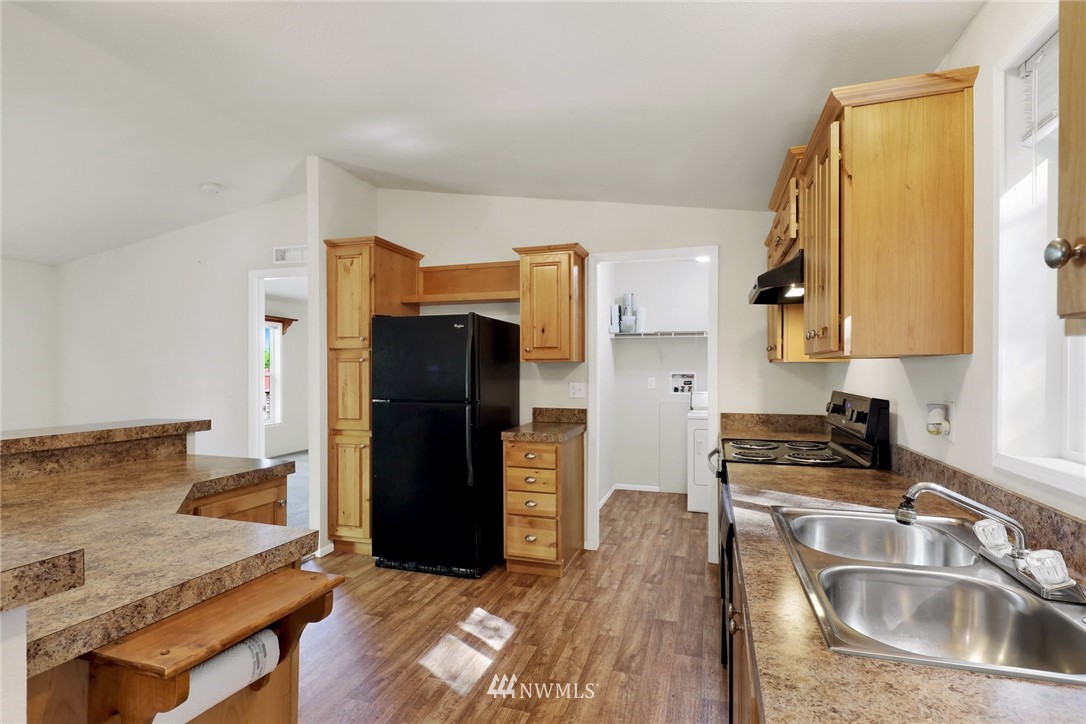 6752 Goodwin Road Everson, WA 98247 - Photo 10 of 28 a kitchen with a sink cabinets and refrigerator