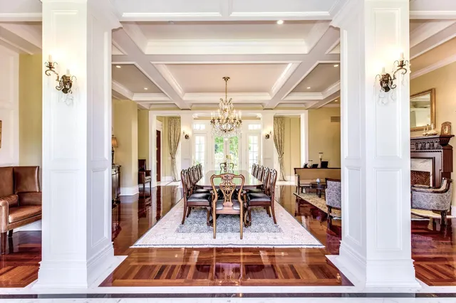 a living room with furniture a chandelier and a fireplace