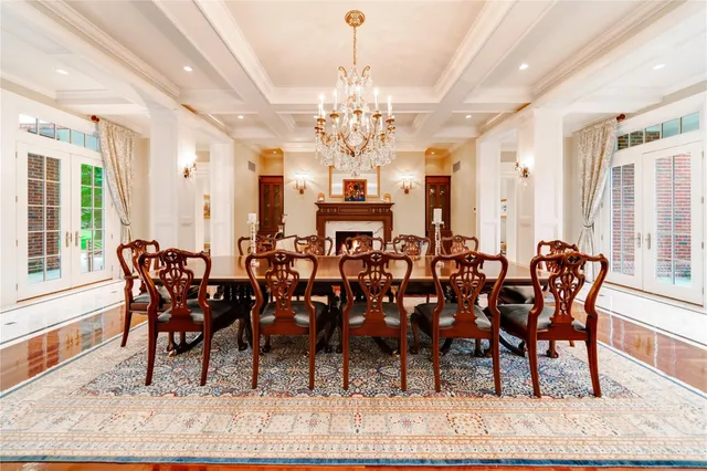 a living room with furniture fireplace and large windows