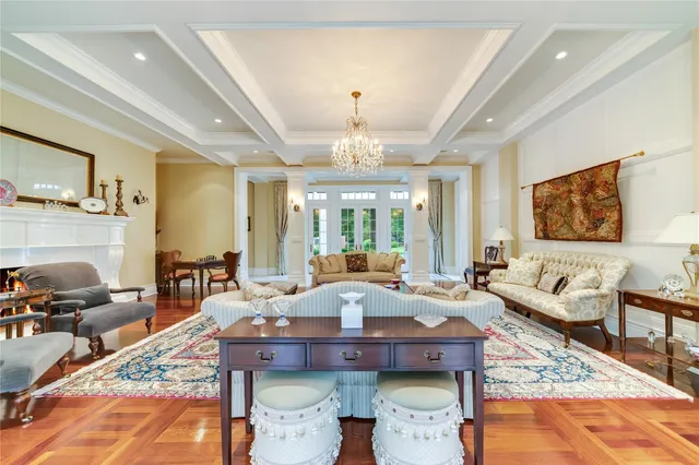 a large dining hall with stainless steel appliances kitchen island granite countertop a table and chairs in it