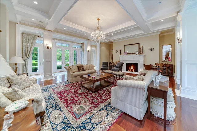 a large white kitchen with stainless steel appliances a sink and cabinets