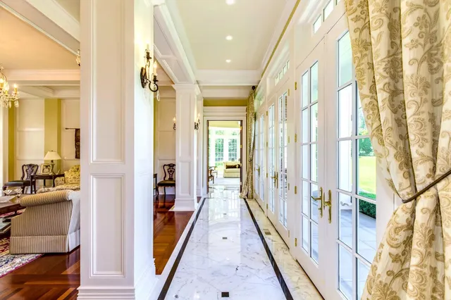 a large kitchen with a counter space a sink appliances and living room view