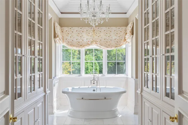 a living room with furniture and large windows