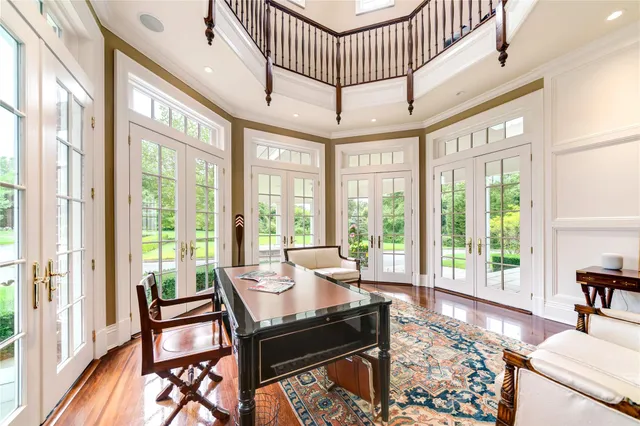 an aerial view of a house with swimming pool a patio and yard