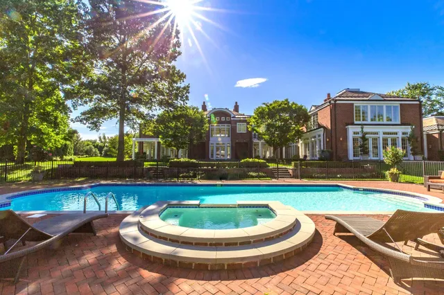 a living room with furniture fireplace and a large window