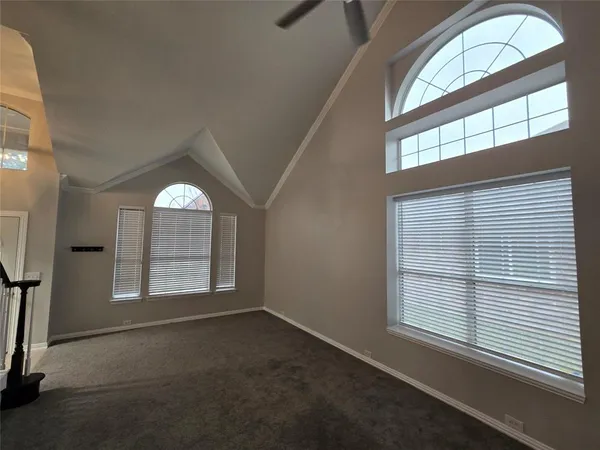 an empty room with windows and mirror