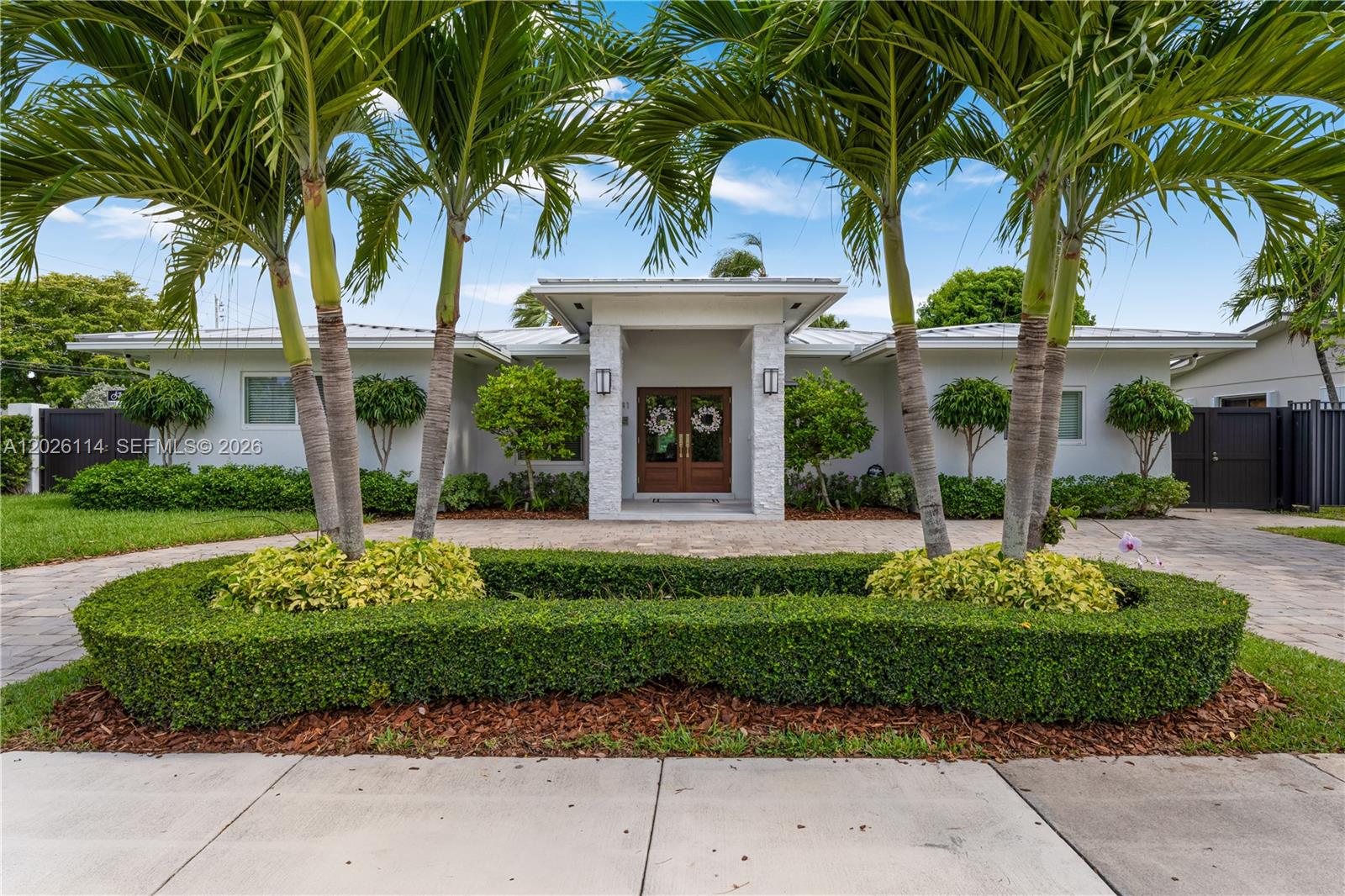 9641 Southwest 66th Street Miami, FL 33173 - Photo 3 of 57 a front view of a house with a garden