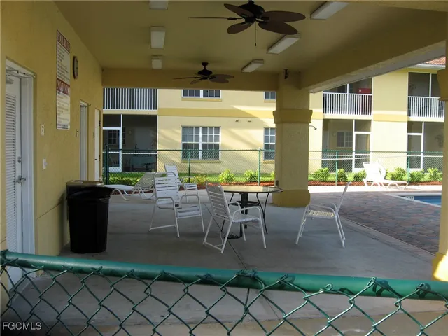 a view of a patio with table and chairs