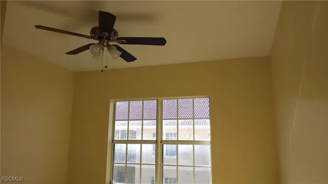 a view of a room with a ceiling fan and a window
