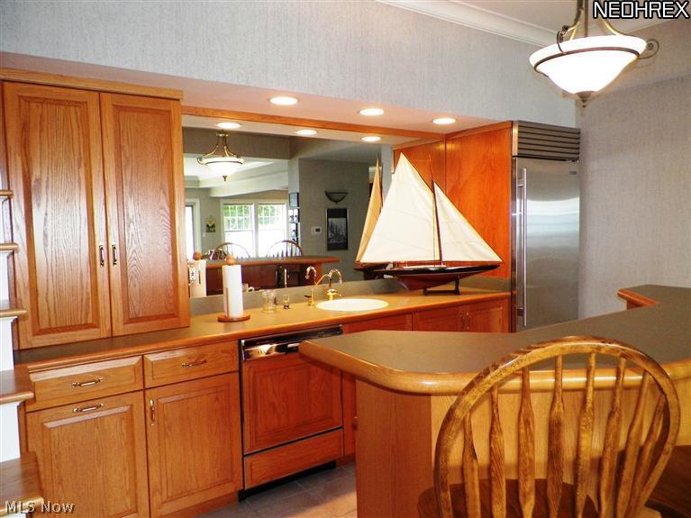 2730 North Bluff Ridge Drive Port Clinton, OH 43452 - Photo 21 of 25 The Lower Level Bar with a Sub zero refrigerator and dishwasher.