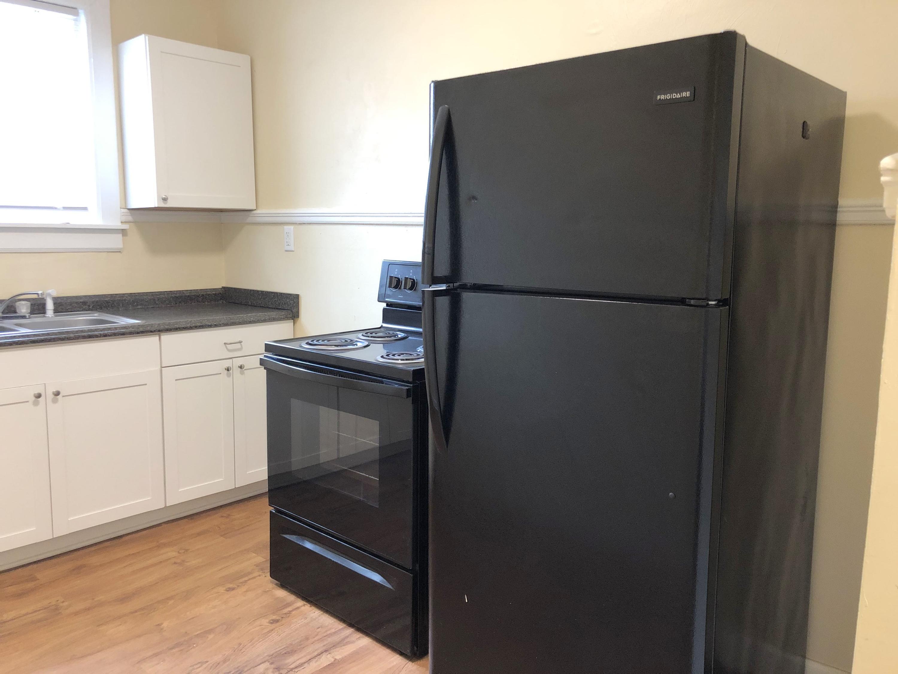 202 Elm Avenue, Unit A8 Roanoke, VA 24016 - Photo 12 of 23 a kitchen with metallic refrigerator and white cabinets
