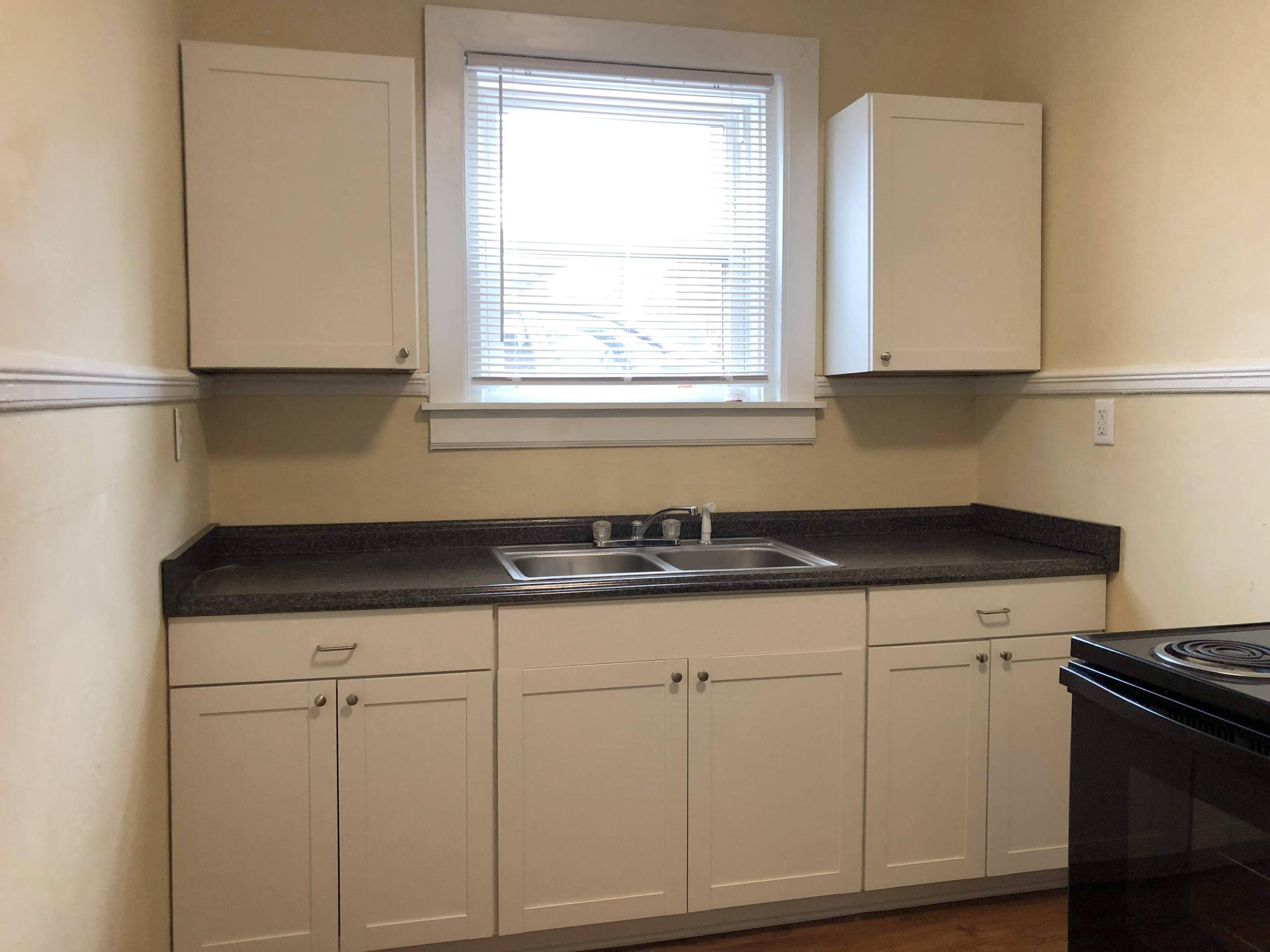 202 Elm Avenue, Unit A8 Roanoke, VA 24016 - Photo 13 of 23 a kitchen with granite countertop white cabinets and sink