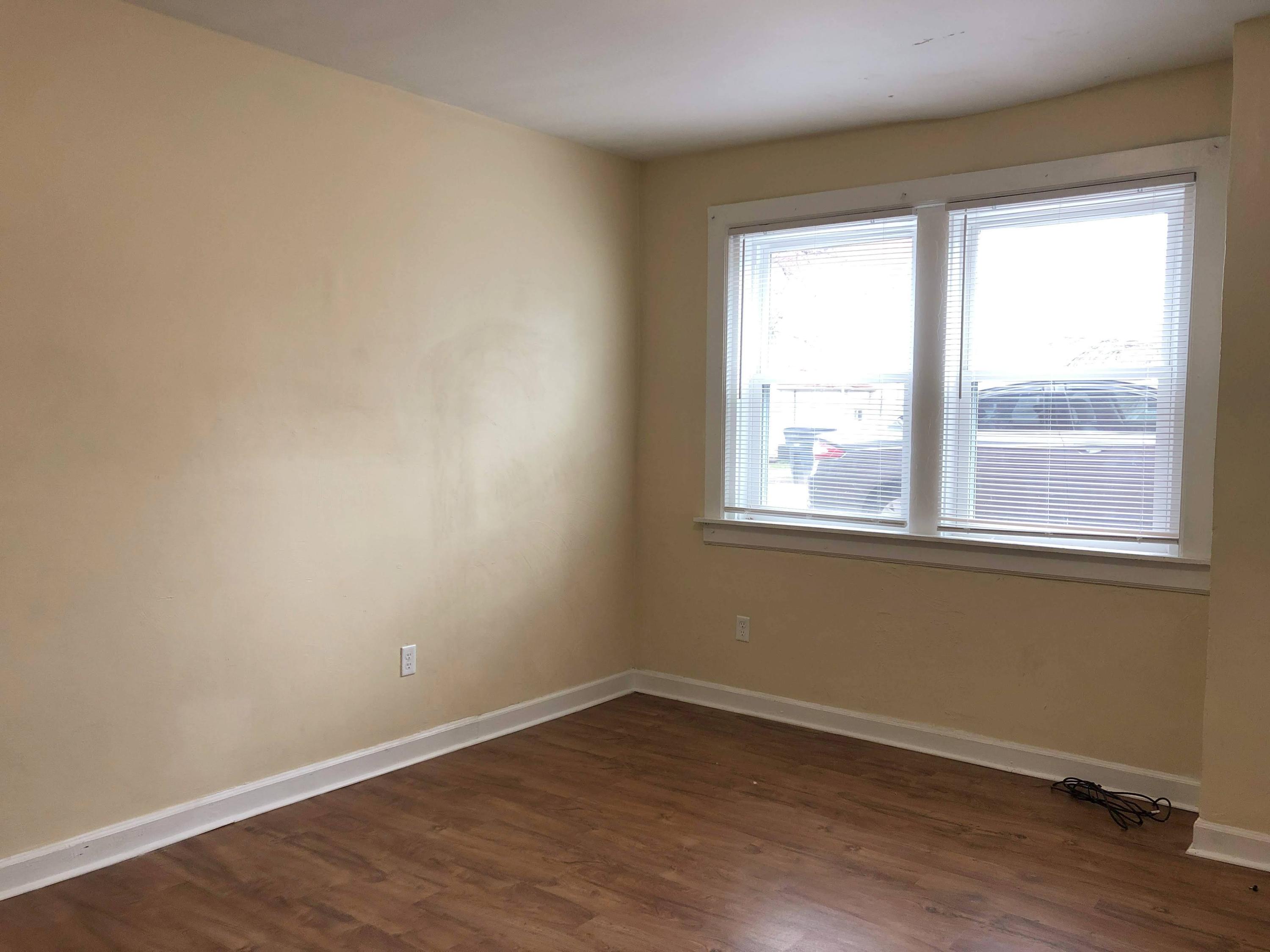 202 Elm Avenue, Unit A8 Roanoke, VA 24016 - Photo 15 of 23 an empty room with wooden floor and windows