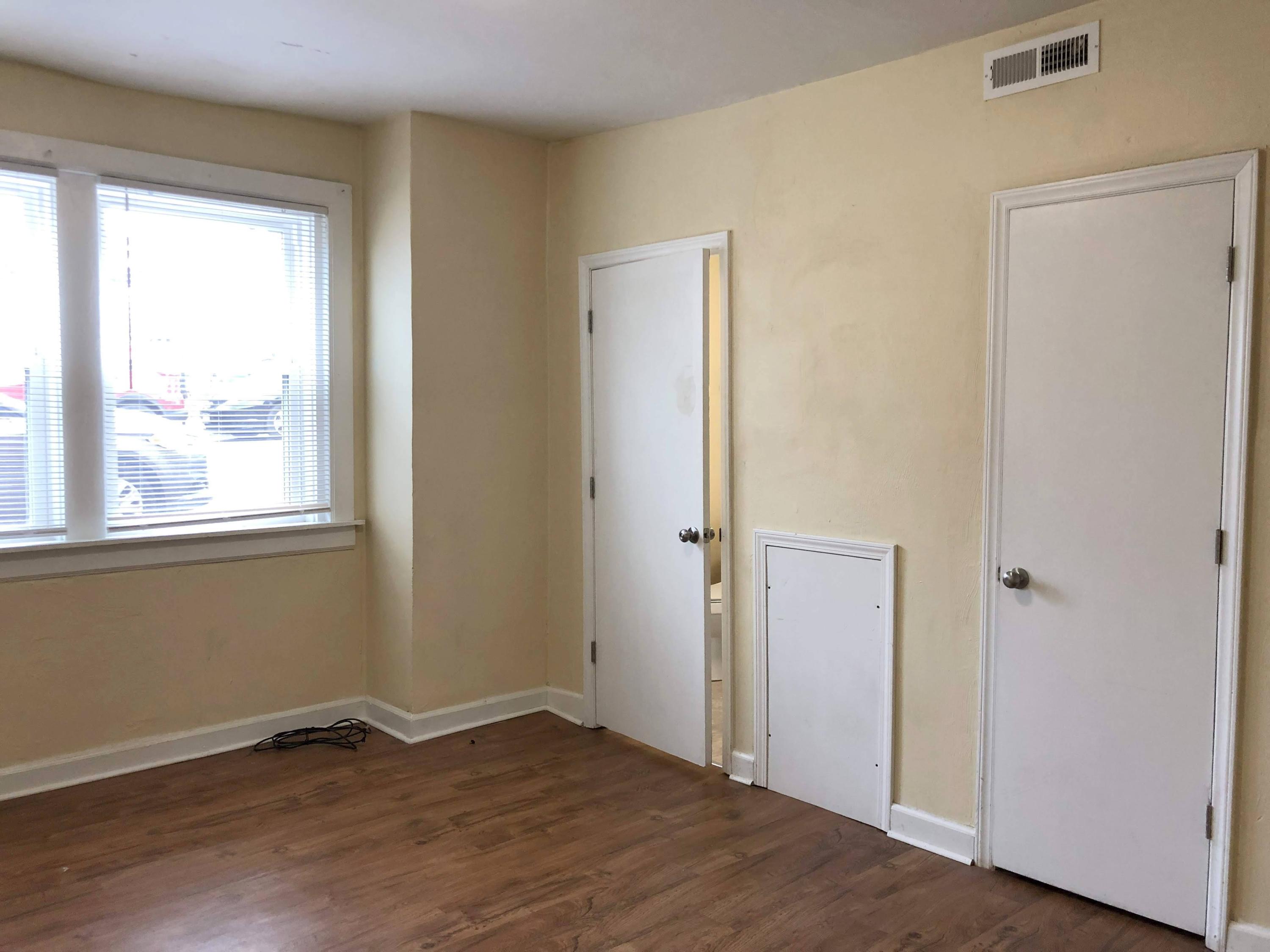 202 Elm Avenue, Unit A8 Roanoke, VA 24016 - Photo 17 of 23 a view of an empty room with wooden floor and a window