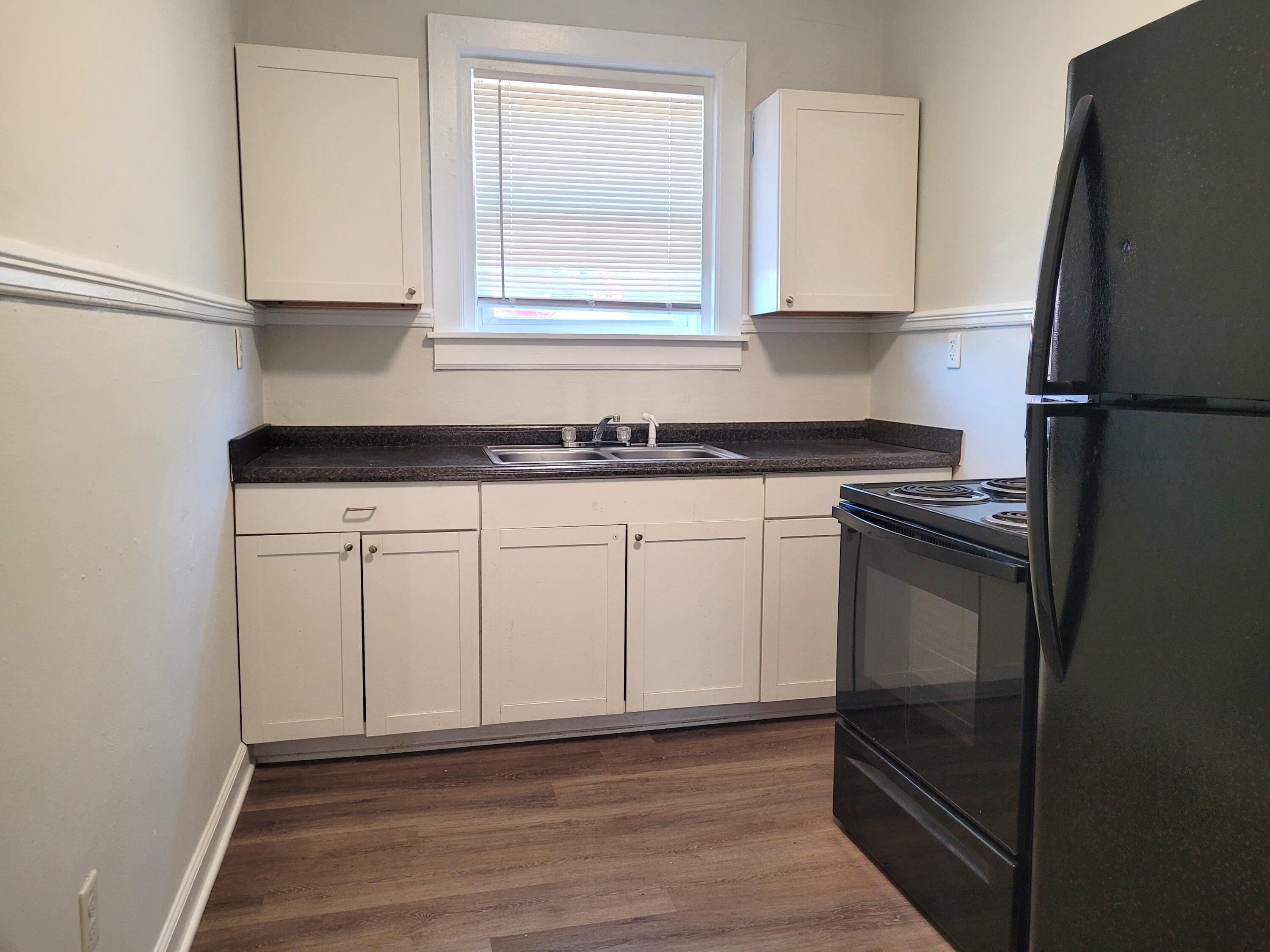 202 Elm Avenue, Unit A8 Roanoke, VA 24016 - Photo 8 of 23 a kitchen with white cabinets and a refrigerator