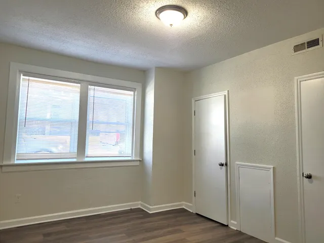 a kitchen with granite countertop white cabinets and refrigerator