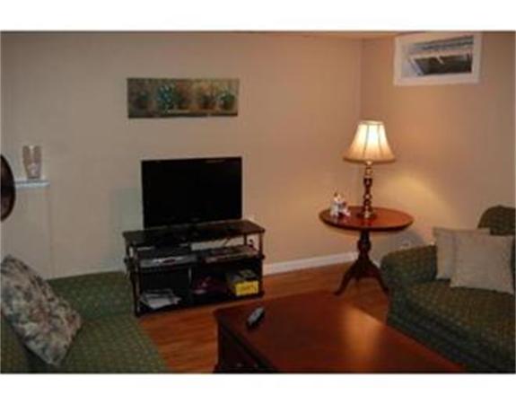 12 Shaw Farm Road, Unit 12 Canton, MA 02021 - Photo 3 of 8 a living room with furniture and a flat screen tv