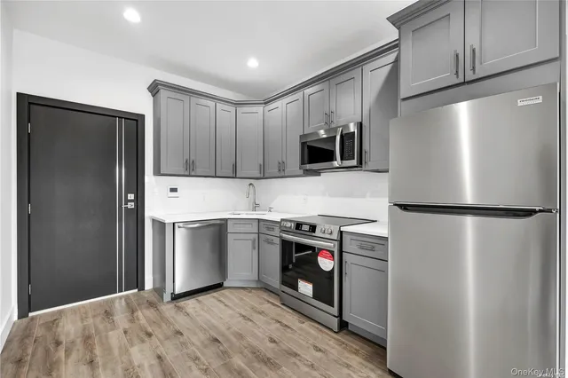 a kitchen with a refrigerator sink and microwave