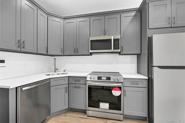 a kitchen with stainless steel appliances granite countertop a refrigerator stove and sink