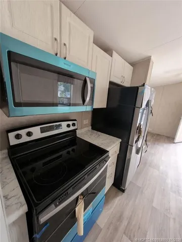 a kitchen with wooden cabinets and a stove top oven