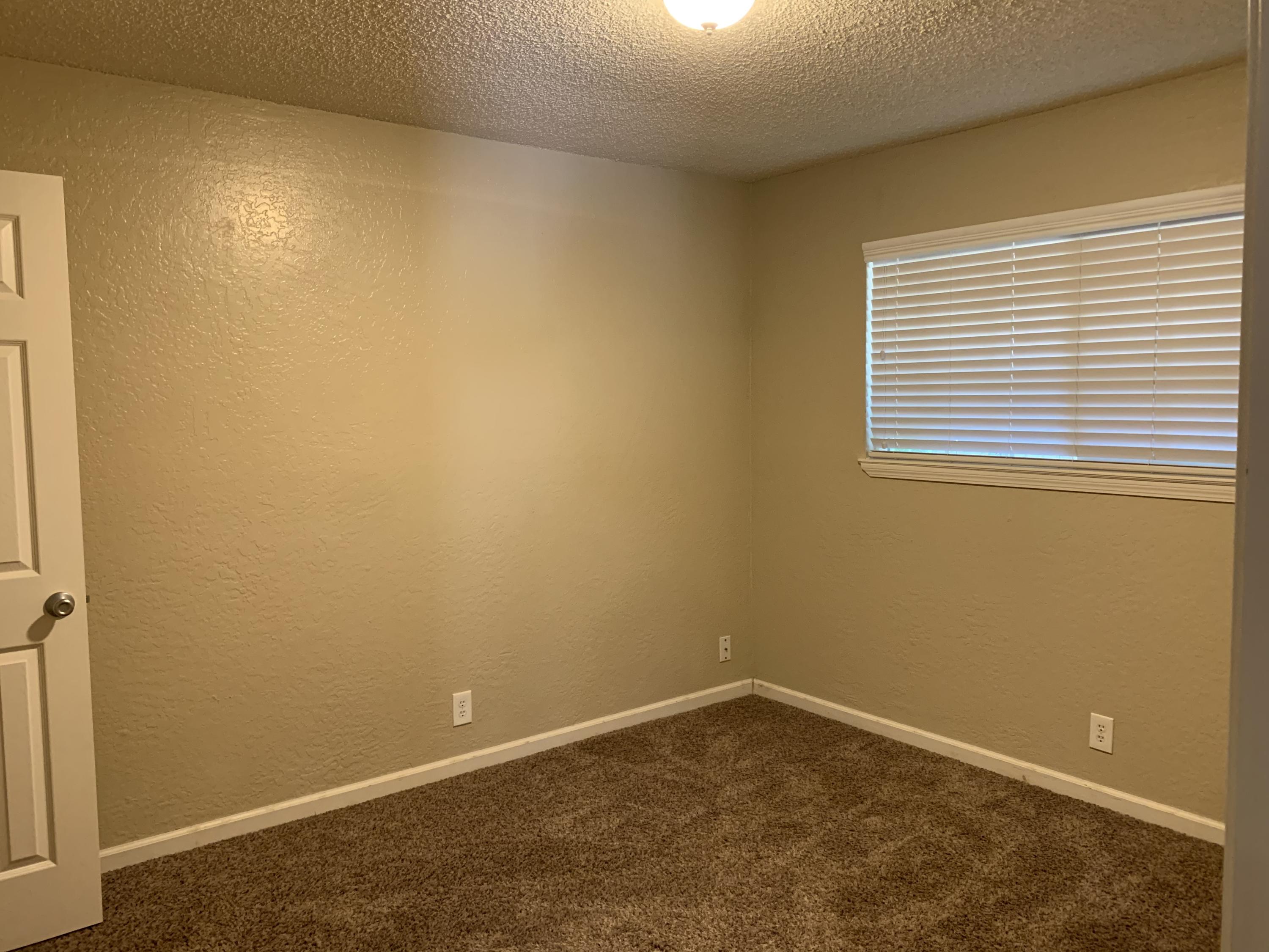 3242 Lawrence Road Redding, CA 96002 - Photo 5 of 17 an empty room with a window
