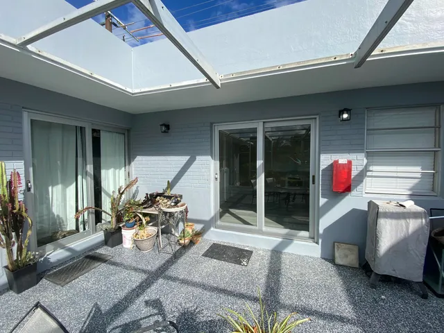 a patio with table and chairs