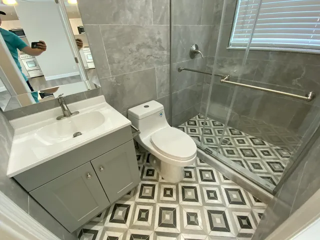 a bathroom with a sink toilet and shower