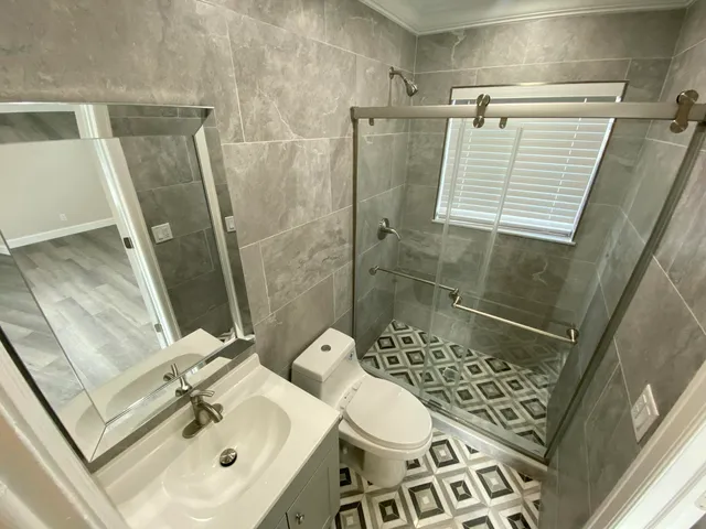 a bathroom with a sink toilet and shower