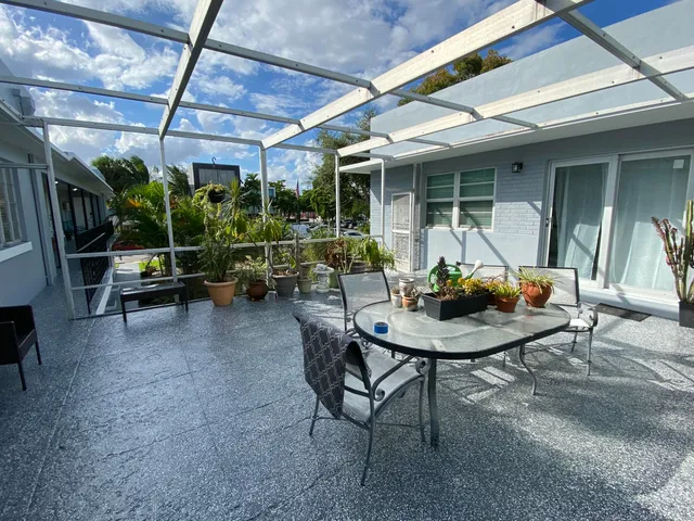 a view of a house with backyard sitting area and porch