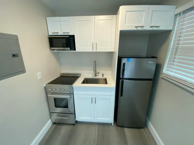 a kitchen with a refrigerator sink and stove