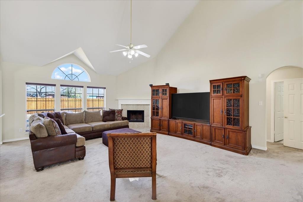 7308 Hawk Lane Sachse, TX 75048 - Photo 10 of 37 a living room with furniture a ceiling fan and a flat screen tv
