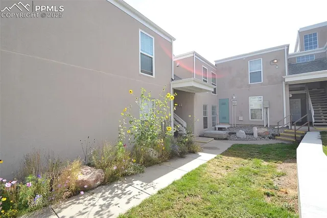a view of a house with backyard and sitting area